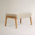 İskeleti dişbudak ağacından yapılmış, dolgulu keten kılıflı ayak uzatma taburesi.